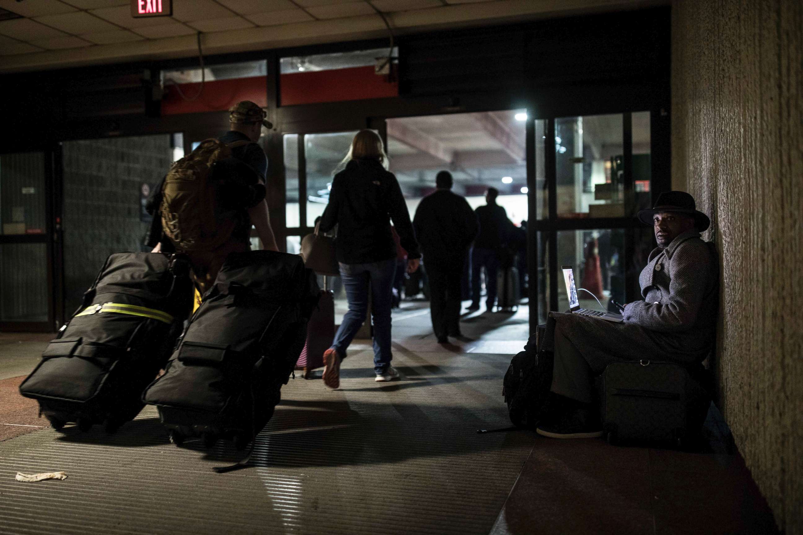 PHOTO: A traveler waits in dark at Hartfield-Jackson Atlanta International Airport, Dec. 17, 2017, in Atlanta.