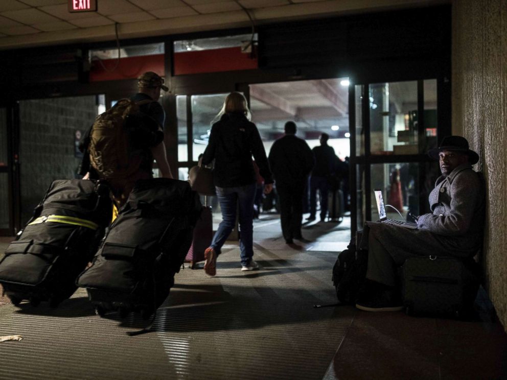 PHOTO: A traveler waits in dark at Hartfield-Jackson Atlanta International Airport, Dec. 17, 2017, in Atlanta.