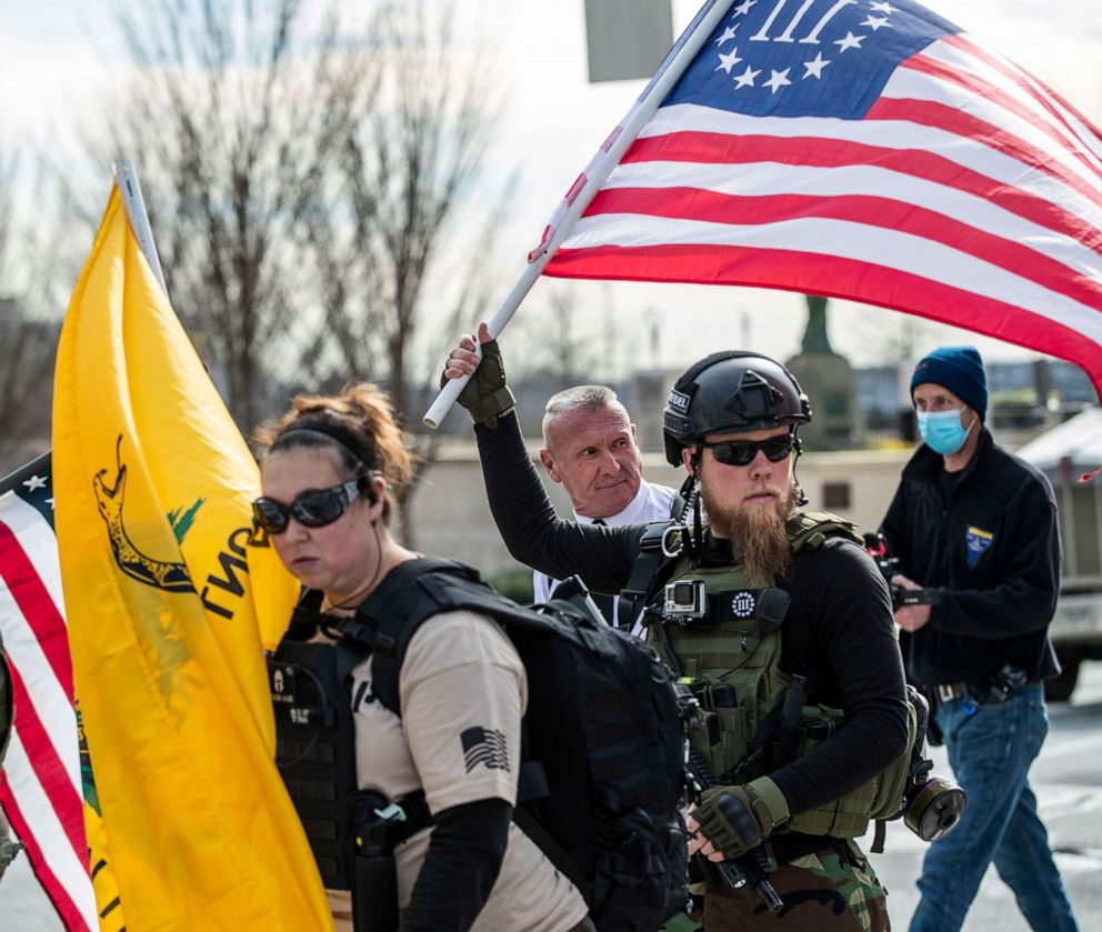 PHOTO: Chester Doles, rear center, leader of American Patriots USA, is surrounded by supporters as he makes his way to a 'Stop the Steal' rally outside of the Georgia State Capitol building, Jan. 6, 2021, in Atlanta.