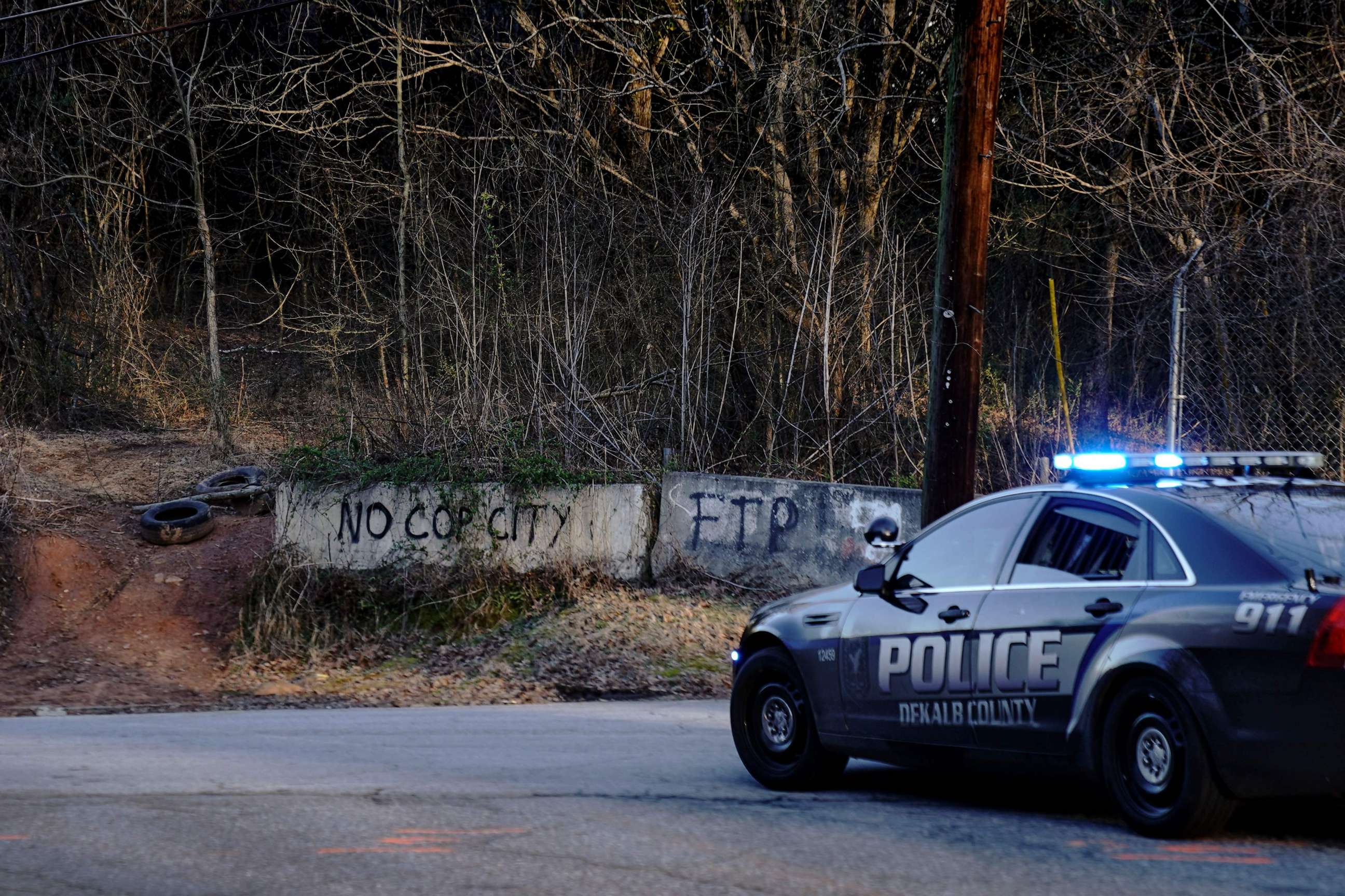 PHOTO: Police drive past the planned site of a public safety training facility that opponents have nicknamed "Cop City" near Atlanta, Georgia, on Feb. 6, 2023.