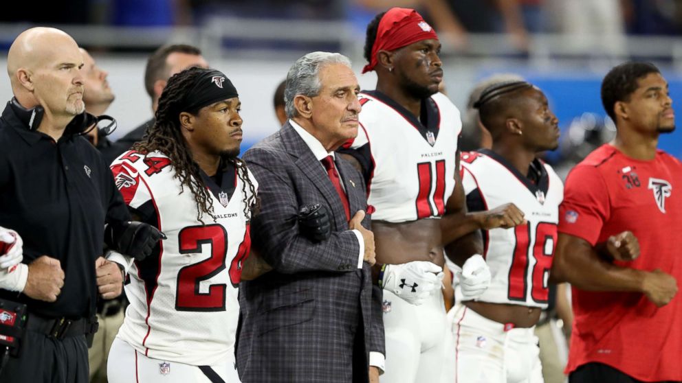 Atlanta Falcons owner Arthur Blank joins arms with his players during the playing of the national anthem prior to the game against the Detroit Lions at Ford Field, Sept. 24, 2017 in Detroit, Mich. 
