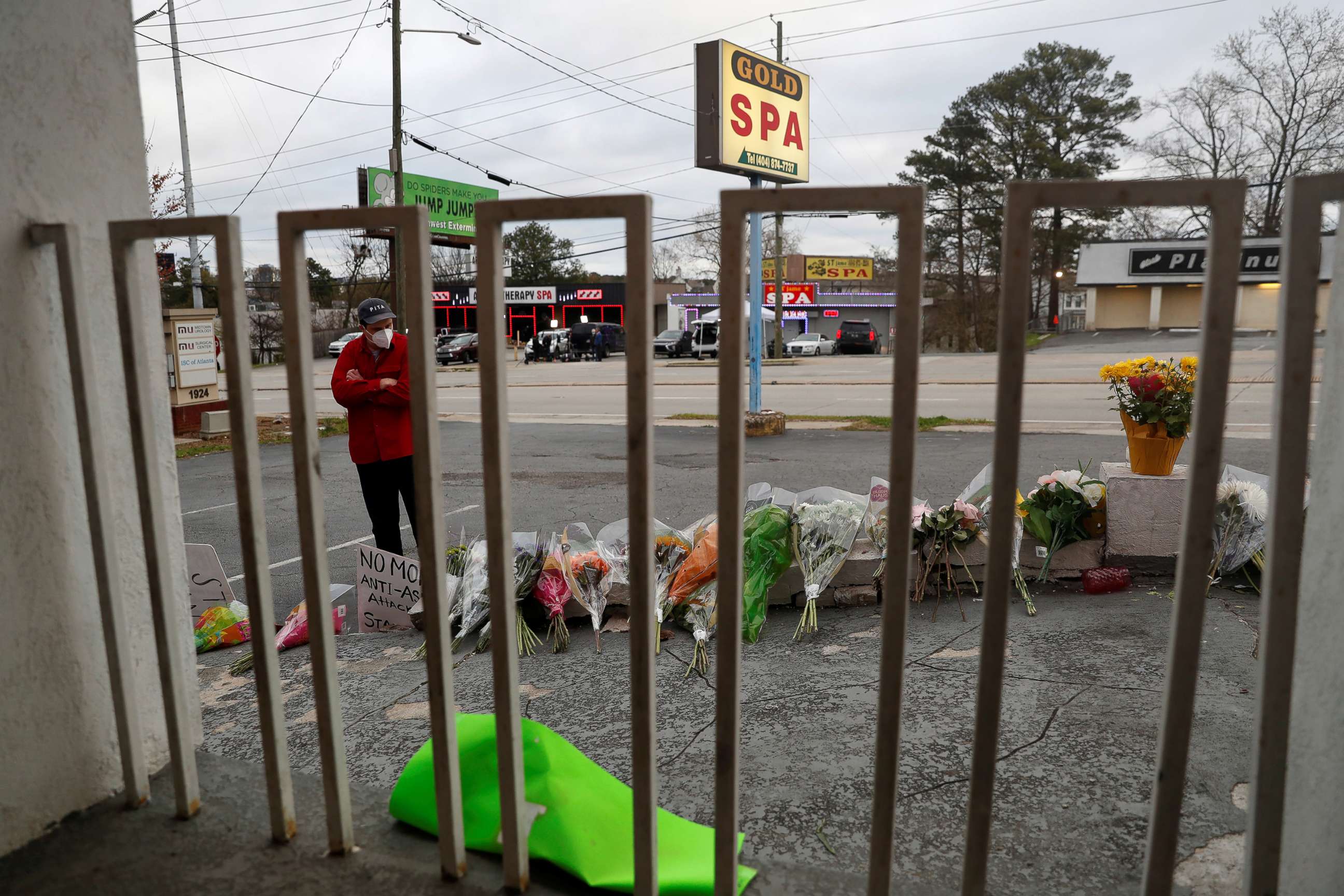 PHOTO: Sasha Hasanbegovic looks down after laying flowers at a makeshift memorial outside the Gold Spa following the deadly shootings in Atlanta, March 19, 2021.