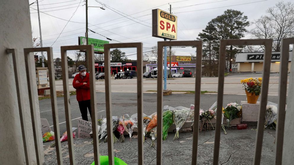 PHOTO: Sasha Hasanbegovic looks down after laying flowers at a makeshift memorial outside the Gold Spa following the deadly shootings in Atlanta, March 19, 2021.