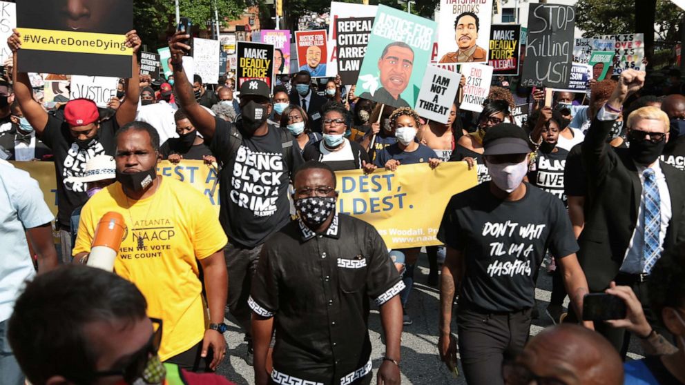 PHOTO: People gather for a civil rights National Association for the Advancement of Colored People (NAACP) protest march, June 15, 2020 in Atlanta.