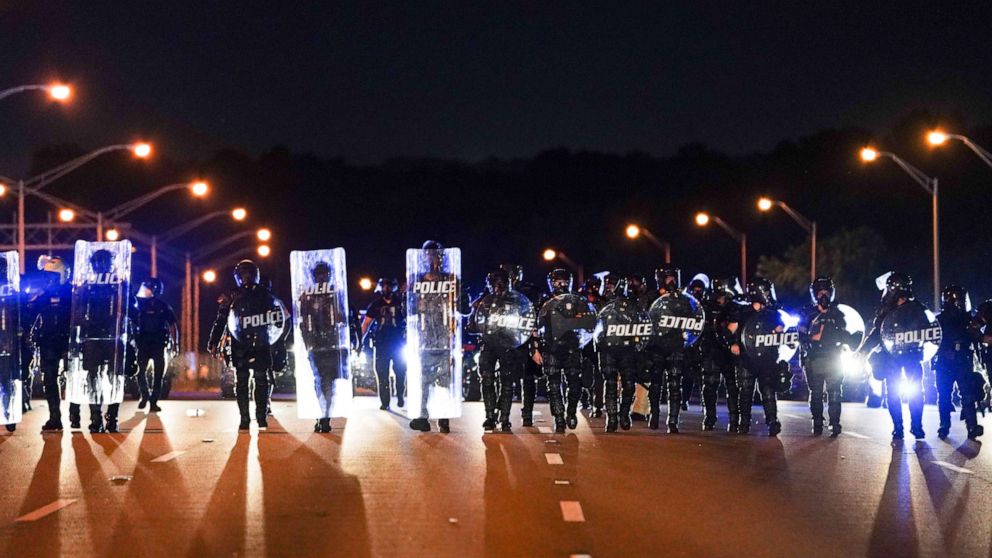 PHOTO: Police with riot shields advance to detain protesters for blocking traffic on a freeway, during a rally against racial inequality and the police shooting death of Rayshard Brooks, in Atlanta, Georgia, on June 13, 2020.