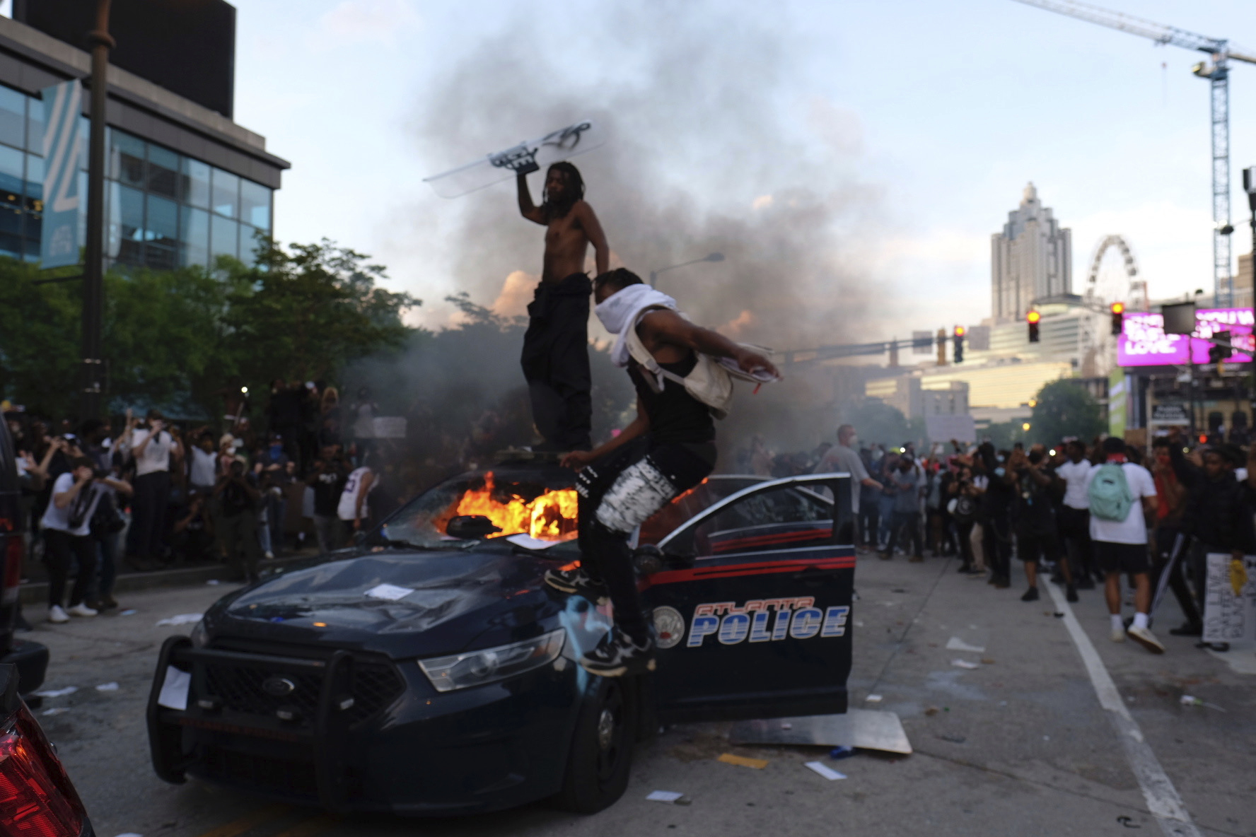 PHOTO: Protesters smash police cars in Atlanta, Friday, May 29, 2020. Protesters marched for George Floyd, who died after being restrained by Minneapolis police officers on Memorial Day.