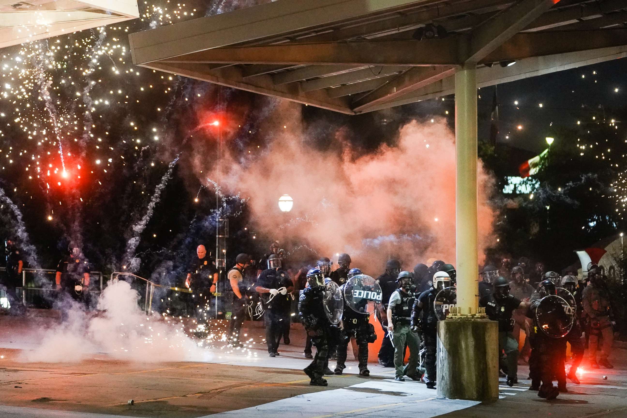 PHOTO: A firework explodes near a police line during a protest in response to the police killing of George Floyd on May 30, 2020, in Atlanta.
