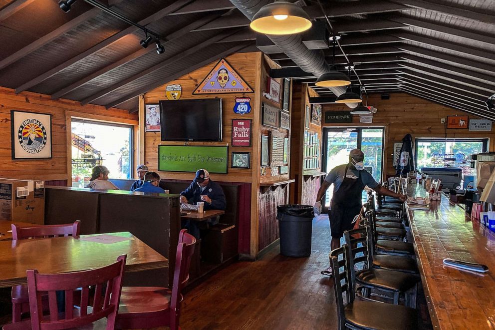 PHOTO: Customers sit and eat at Moe's Original BBQ restaurant in Atlanta, on April 27, 2020.