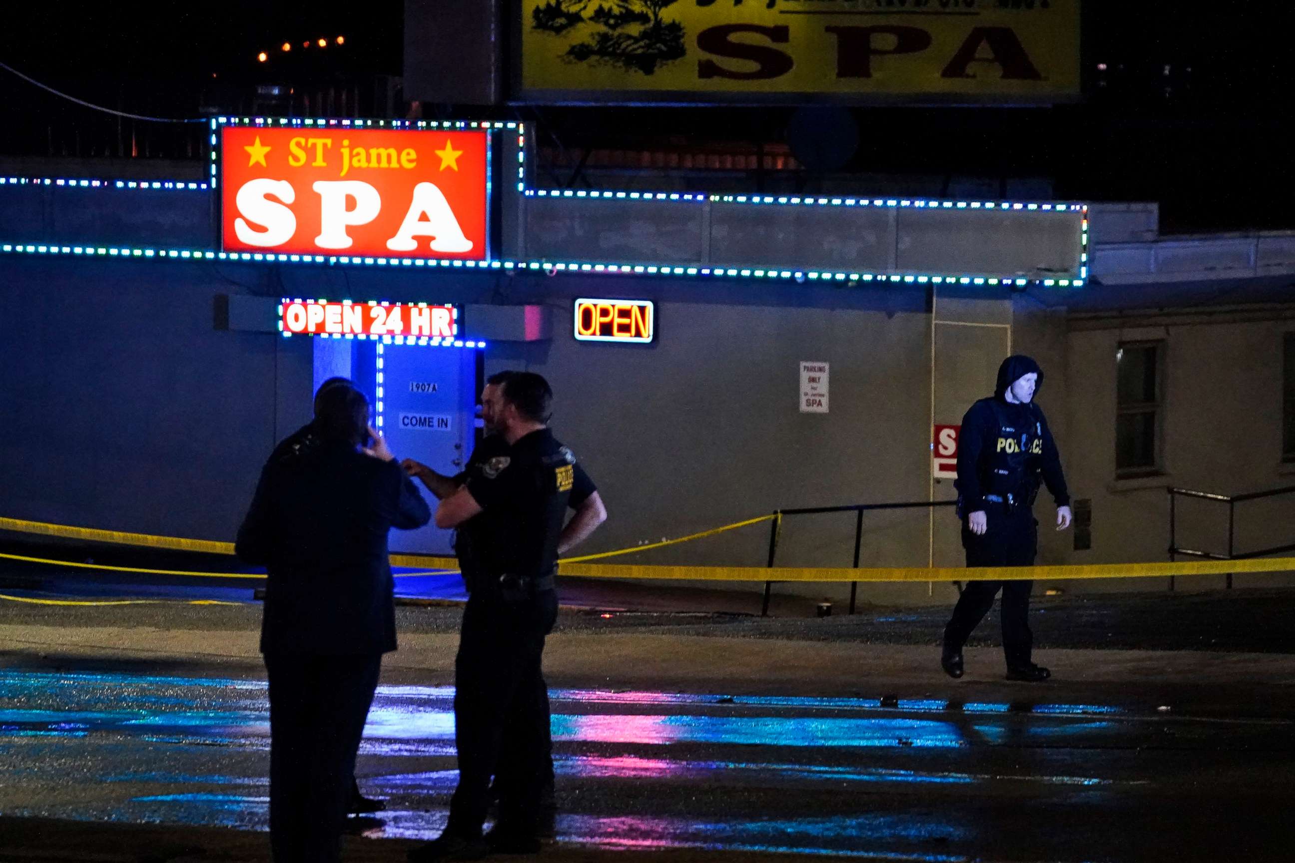 PHOTO: Law enforcement officials gather outside a spa following a shooting, March 16, 2021, in Atlanta.
