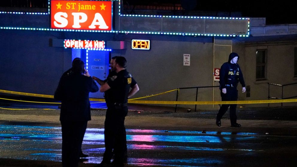 PHOTO: Law enforcement officials gather outside a spa following a shooting, March 16, 2021, in Atlanta.