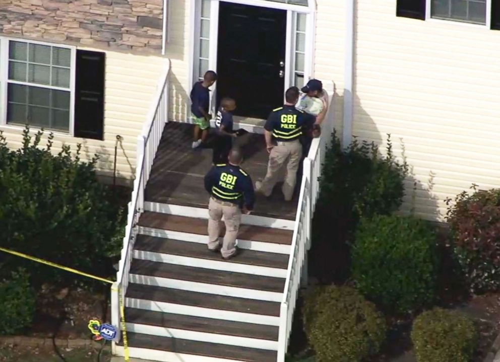 PHOTO: Investigators interact with people following a shooting in Locust Grove, Ga., on Feb. 9, 2018.