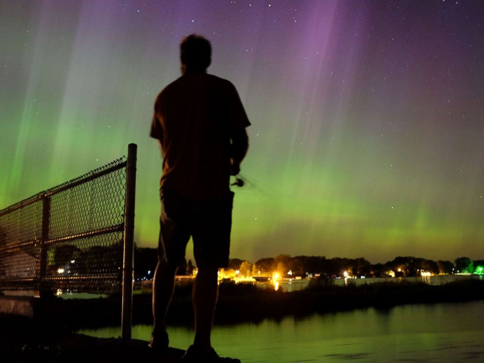   PHOTO: Wade Kitner looks at the northern lights while fishing in Ventura, Iowa, June 23, 2015. 