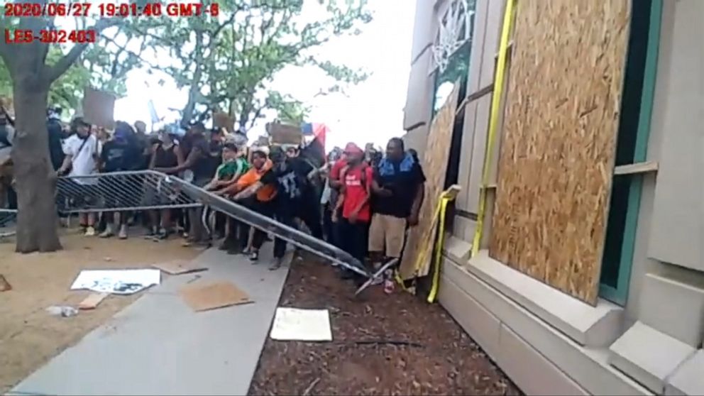 PHOTO: An image made from body camera footage released by the Aurora Police Department in Colorado, shows protesters pushing down a barrier on June 27, 2020.