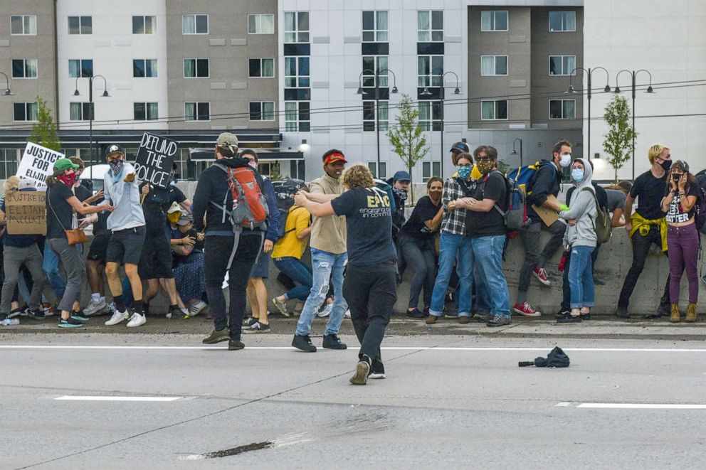 PHOTO: A man shoots at a Jeep speeding through a crowd of people protesting the death of Elijah McClain on I-225 on July 25, 2020 in Aurora, Colorado.