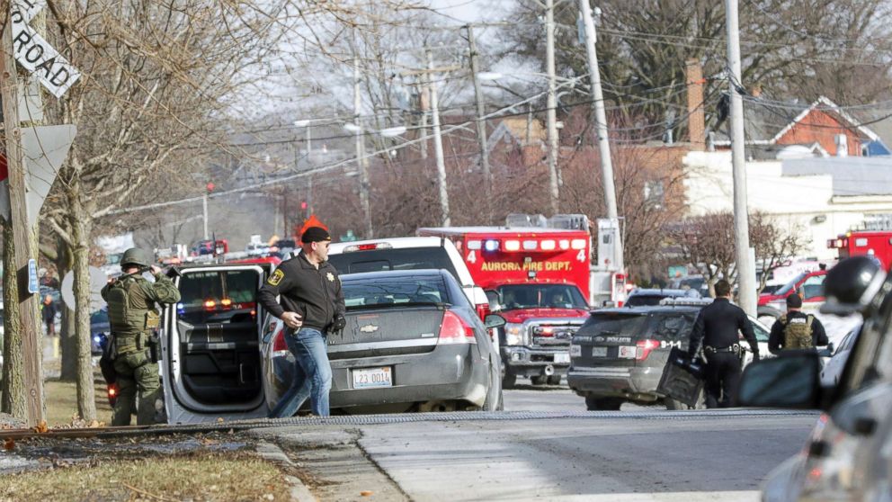 PHOTO: Law enforcement personnel gather near the scene of a shooting at an industrial park in Aurora, Ill., on Friday, Feb. 15, 2019.