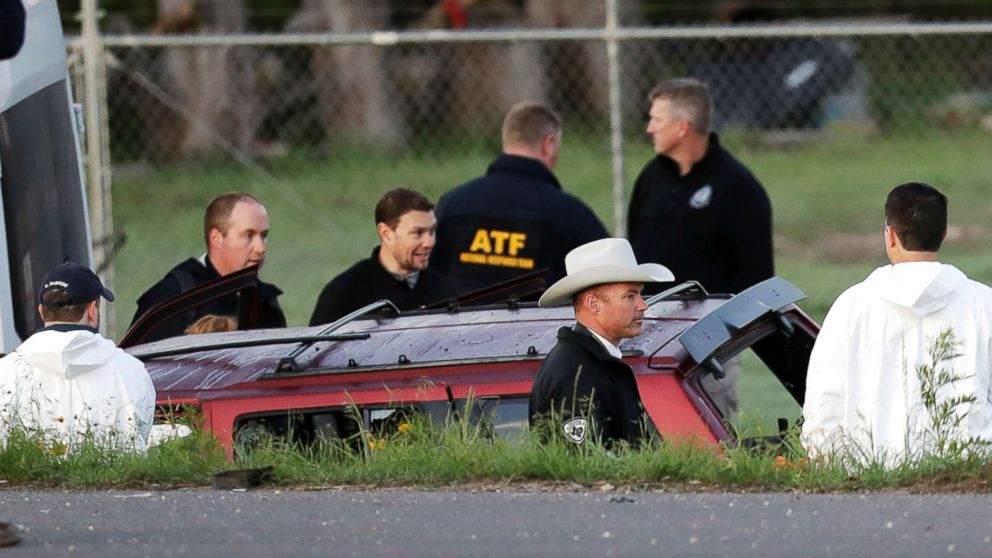 Officials investigate the scene where a suspect in a series of bombing attacks in Austin blew himself up as authorities closed in, March 21, 2018, in Round Rock, Texas.