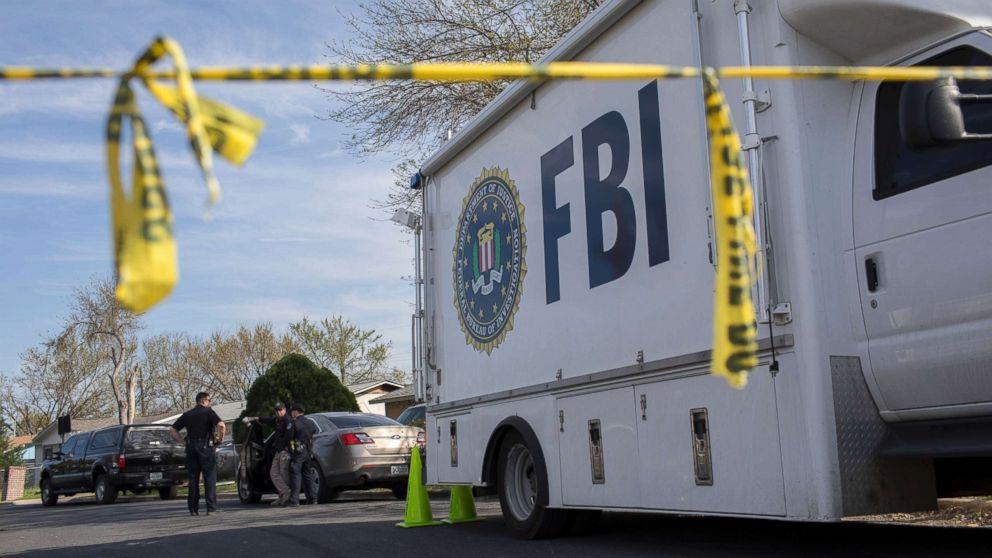 An FBI vehicle is parked on a street where a package bomb exploded the day before, in Austin, Texas, March 13, 2018. In the span of 10 days in Austin, two people have been killed.