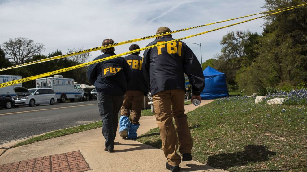 FBI walk to the scene of an explosion that injured two people in southwest Austin, March 19, 2018.