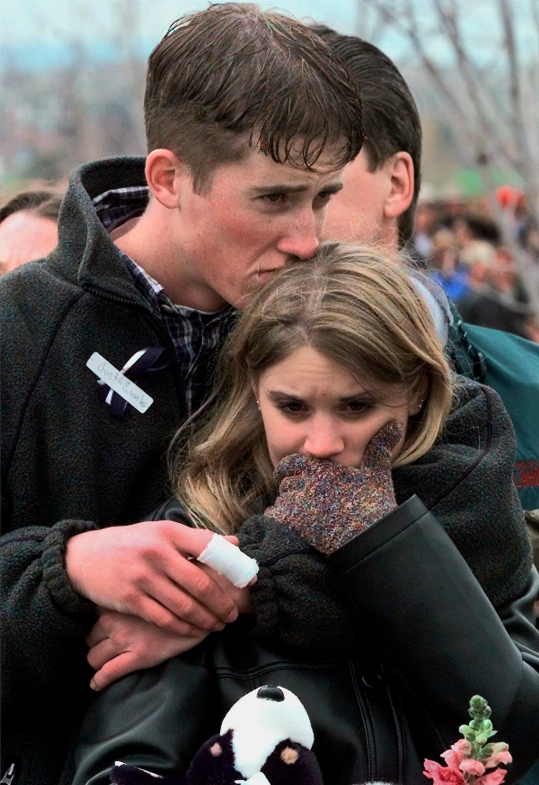 PHOTO: In this April 25, 1999 file photo, shooting victim Austin Eubanks hugs his unidentified girlfriend during a community wide memorial service in Littleton, Colo., for the victims of the shooting rampage at Columbine High School the previous week.