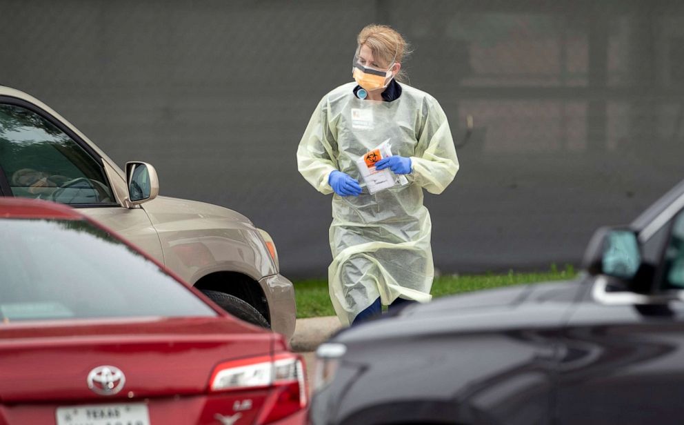 PHOTO: A medical provider works at a drive-through coronavirus testing station at Baylor Scott & White Clinic on Burnet Road, March 15, 2020, in Austin, Texas.