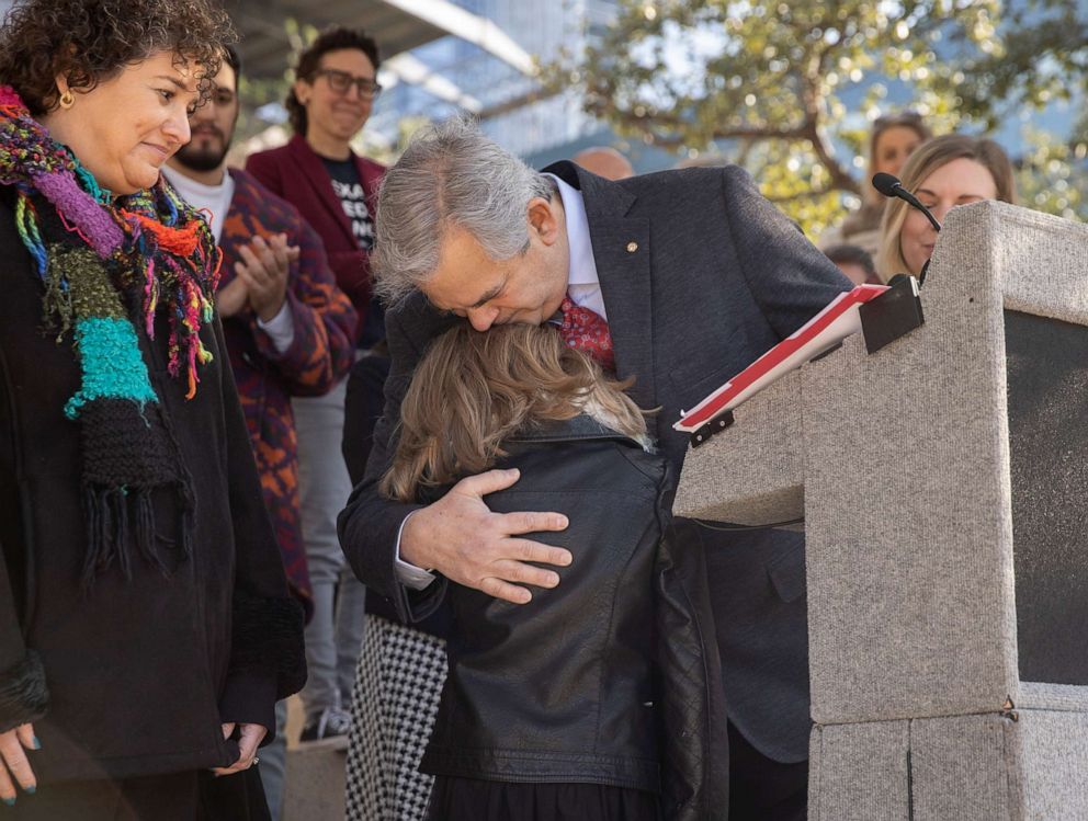 PHOTO: Mayor Steve Adler hugs Kai Shappley, 11, who is transgender, after reading a proclamation declaring the city a safe and inclusive one for transgender families at City Hall in Austin, Texas on March 9, 2022.