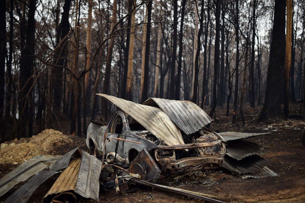PHOTO: A charred vehicle gutted by bush fires in Mogo Village in Australia's New South Wales state, sits among the burned debris, Jan. 6, 2020.