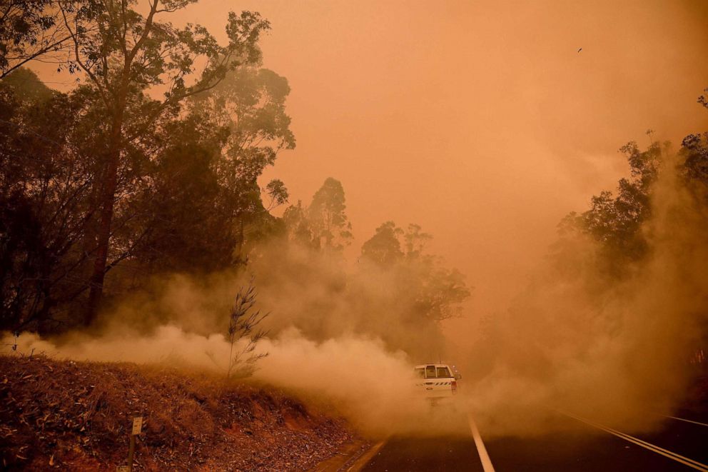 PHOTO: Firefighters tackle a bushfire in thick smoke in the town of Moruya, south of Batemans Bay, in New South Wales, Australia, on Jan. 4, 2020.