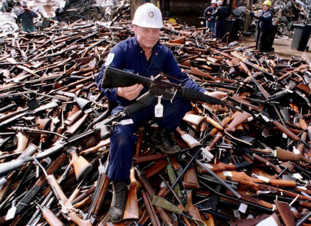 PHOTO: A security expert holds up an Armalite rifle, similar to the one used in the Port Arthur massacre, while sitting on a pile of weapons in Melbourne, Australia, Sept. 8, 1996.