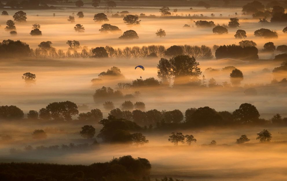 PHOTO: Early morning mist lingers in fields as the autumn sun rises over the Somerset Levels on the Autumn Equinox near Glastonbury, Sept. 22, 2017, in Somerset, England.