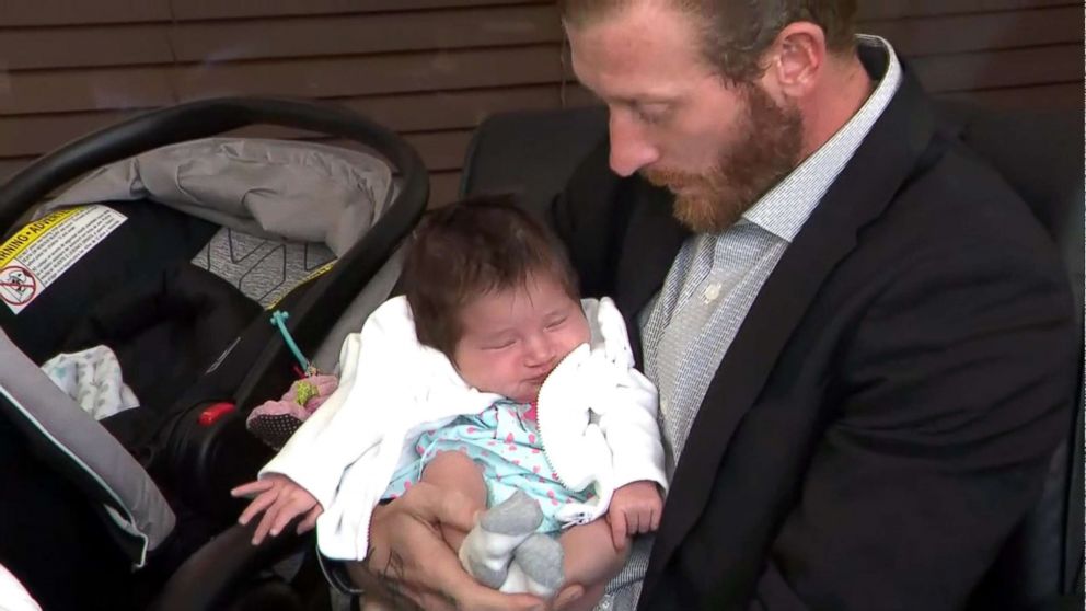 PHOTO: Justin Johnson holds his daughter at a press conference about a law suit he and Rebecca Sanders are filing against the Miccosukee tribe and Baptist Hospital after their baby daughter was taken by a tribal police officer after she was born.