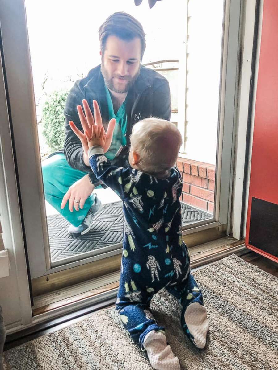 PHOTO: Alyssa Burks posted this photo to Facebook of her husband Jared, who is a resident  physician, visiting with his son during the coronavirus outbreak. 
 