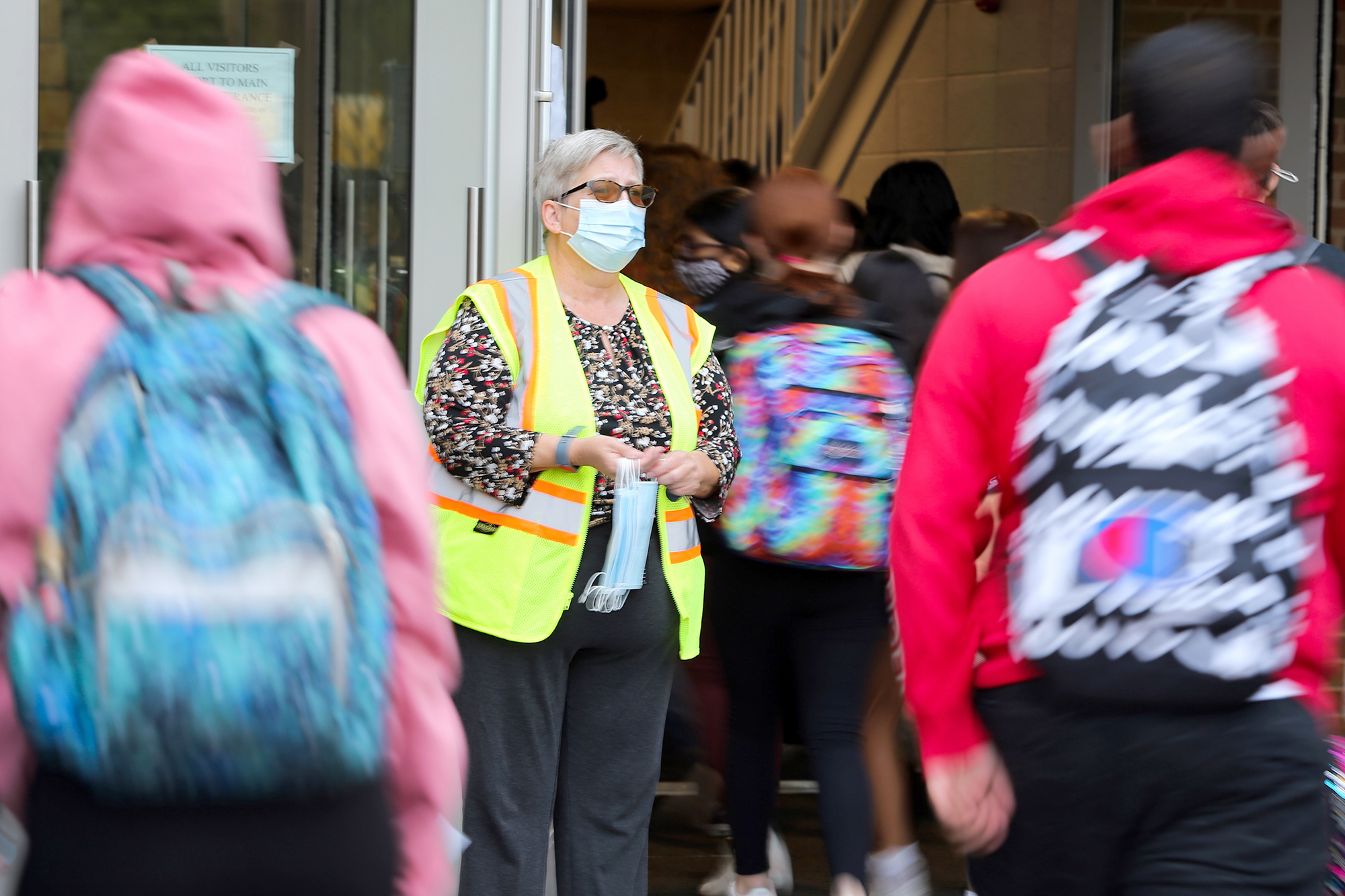 PHOTO: Dr. Diane Niles, assistant principal, makes sure all students are wearing masks as they arrive for the day and has masks available for any student who needs one in Middletown, Conn., Oct. 6, 2021.