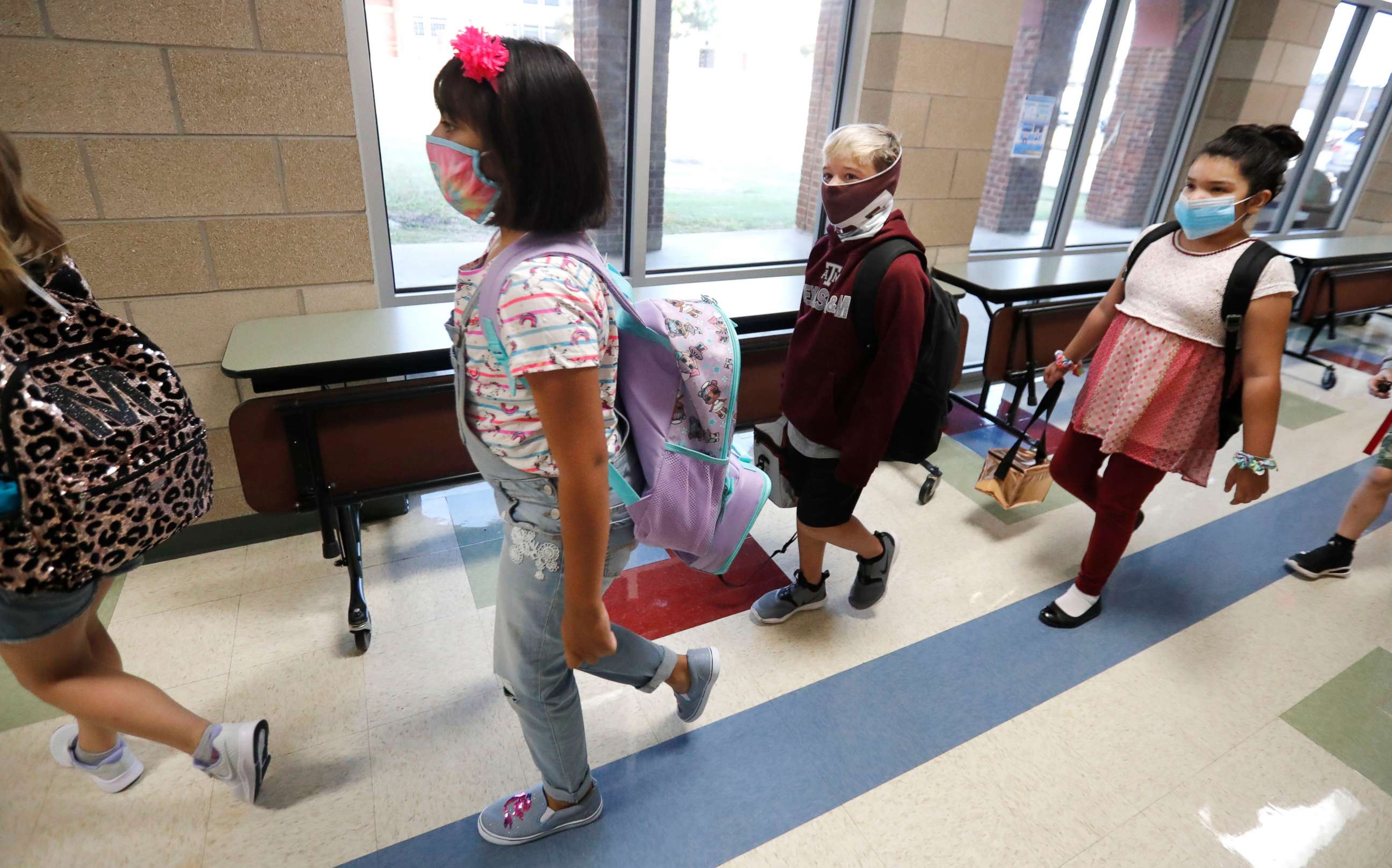 PHOTO: Students wearing masks to prevent the spread of COVID19 walk to class to begin their school day in Godley, Texas, Aug. 5, 2020.