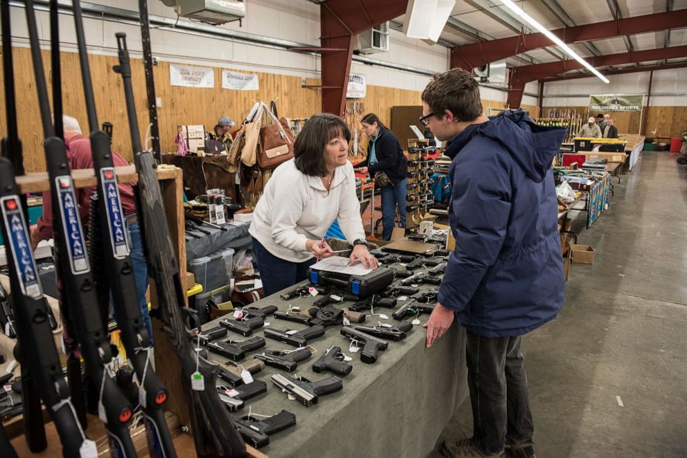 PHOTO: A licensed gun dealer works on a federal background check on a buyer at a gun show in Livingston, Mont., Feb. 7, 2016.