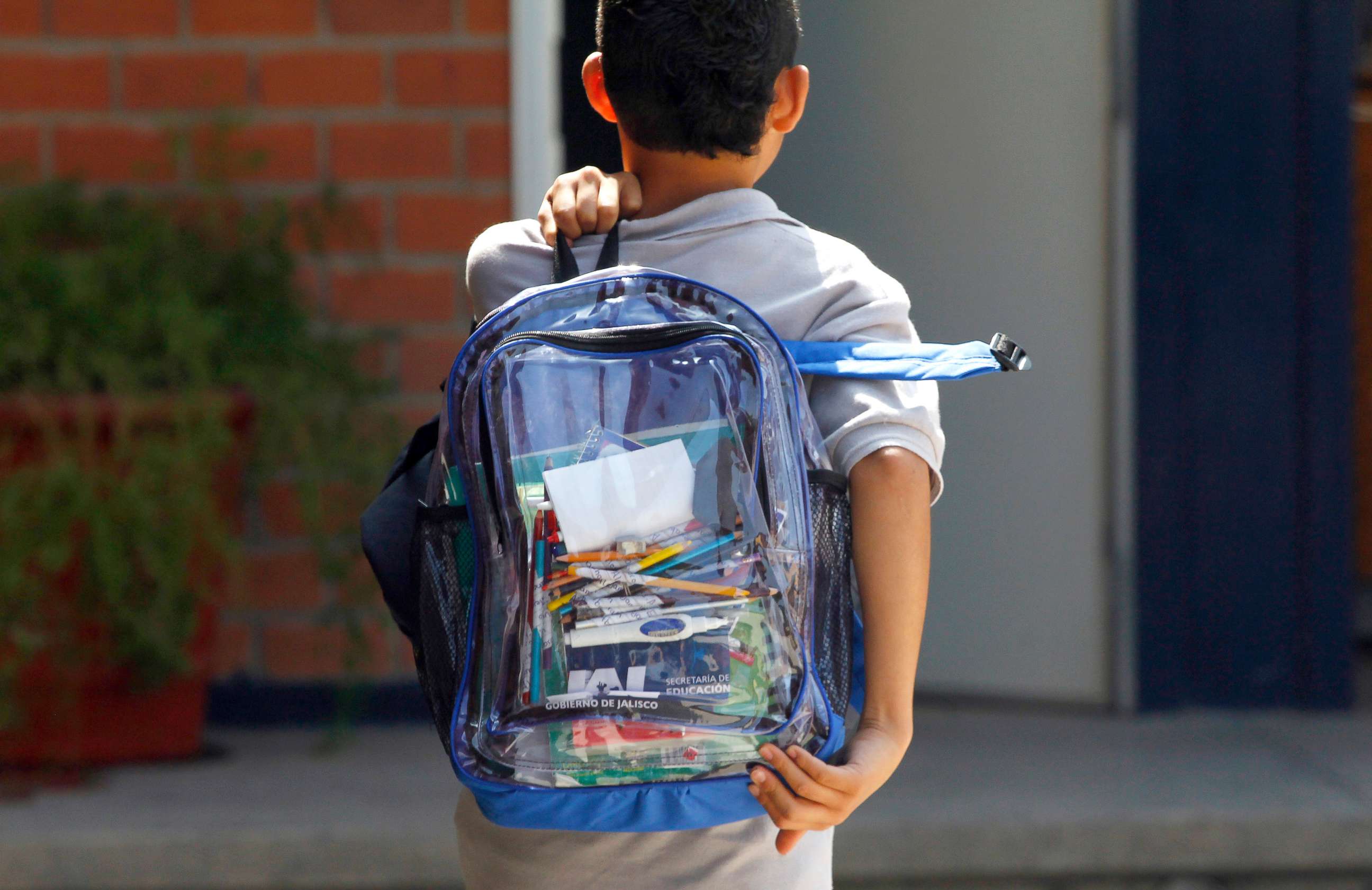 PHOTO: A school student carries a transparent backpack.