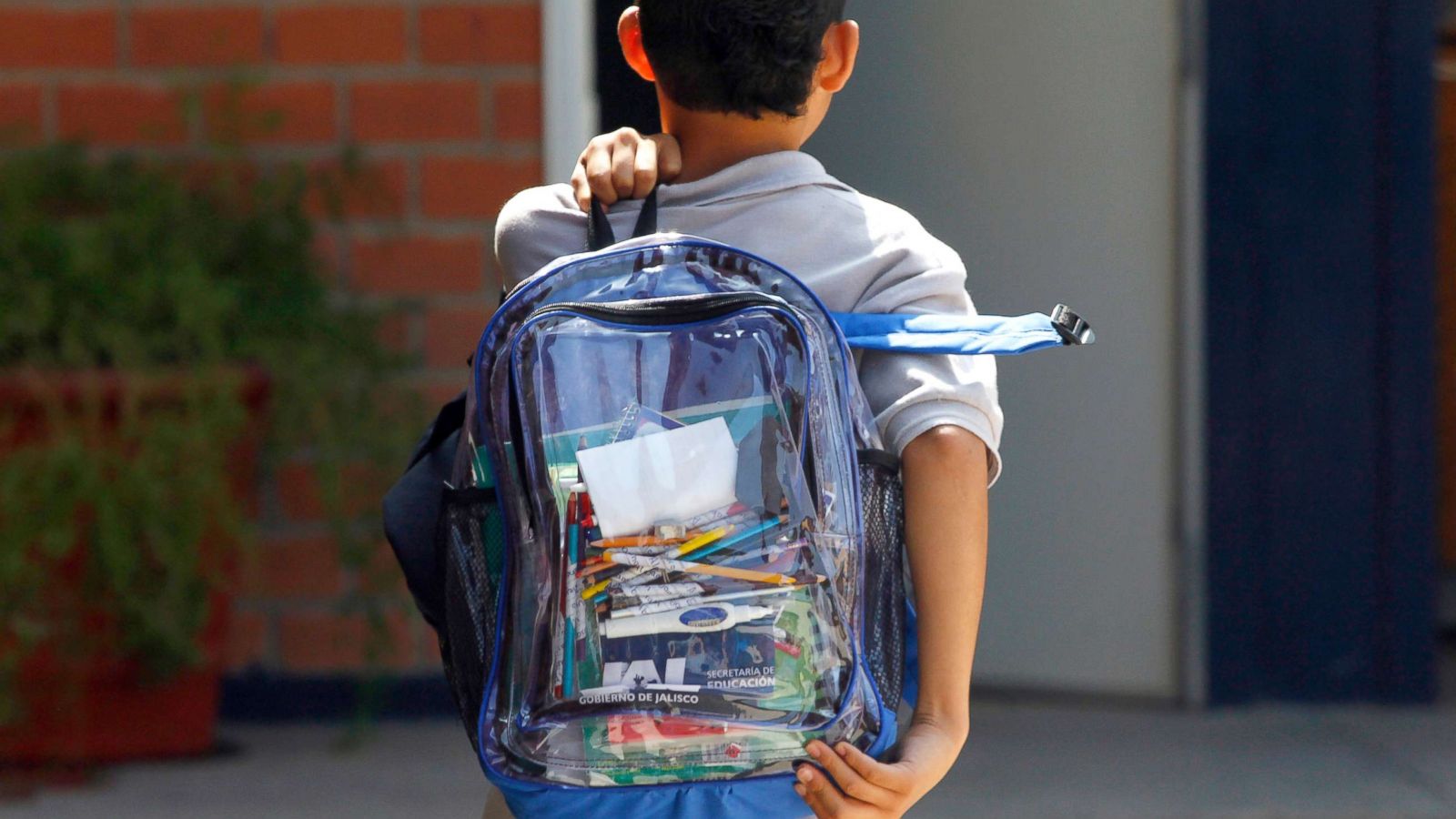 PHOTO: A school student carries a transparent backpack.