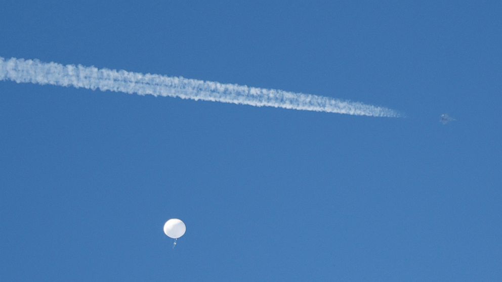 PHOTO: A jet flies past a suspected Chinese spy balloon as it floats off the coast in Surfside Beach, South Carolina, February 4, 2023.