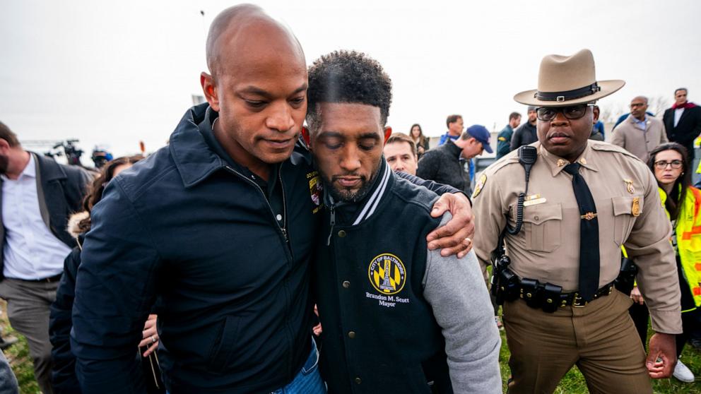 PHOTO: Maryland Governor Wes Moore (L) and Baltimore Mayor Brandon Scott embrace following a press conference at the scene of the Francis Scott Key Bridge collapse in Baltimore, Md, Mar. 26, 2024. 
