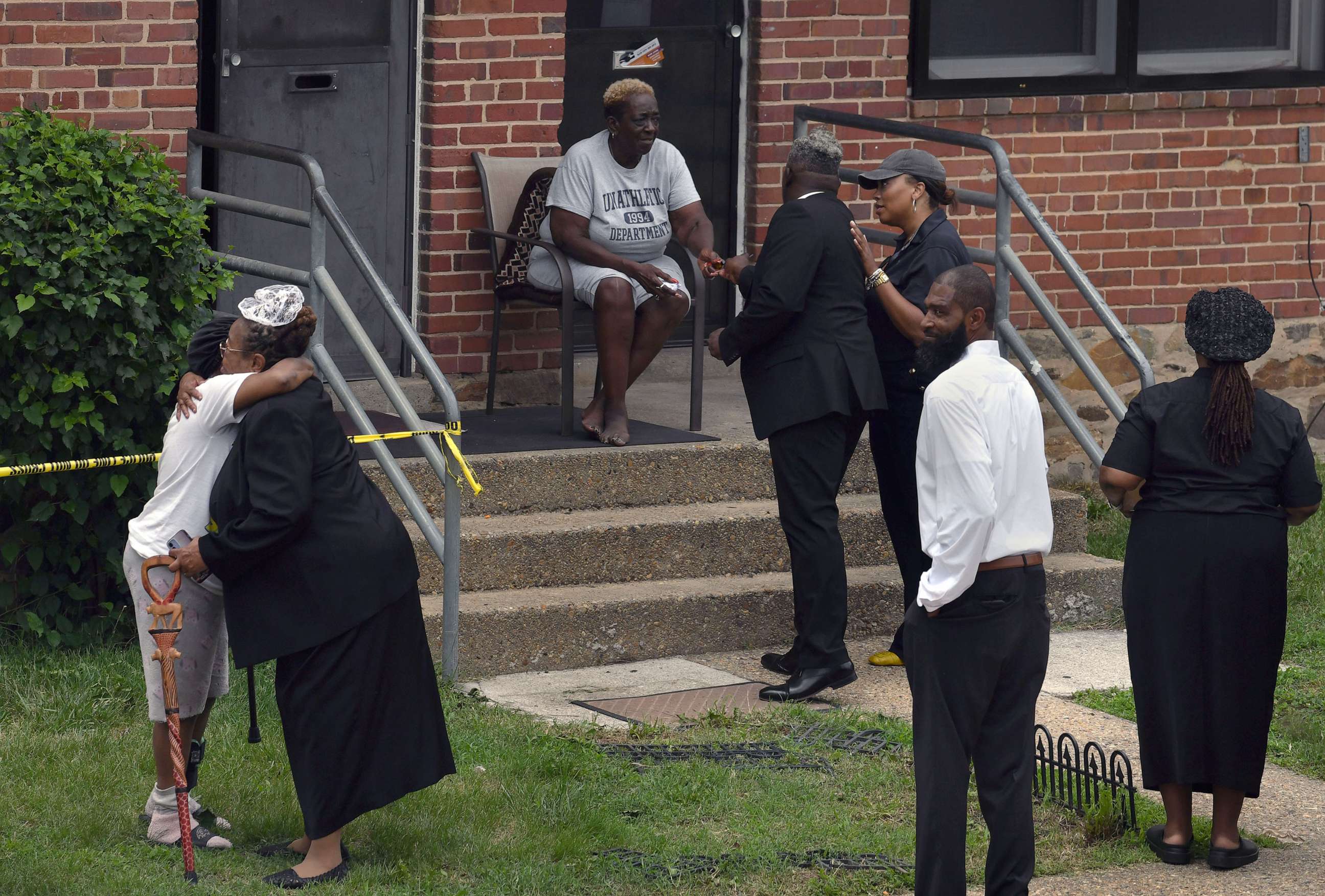 PHOTO: Parishioners from Kingdom Life Church pray with residents after a mass shooting during a block party at the Brooklyn Homes neighborhood in Baltimore. Md., July 2, 2023.
