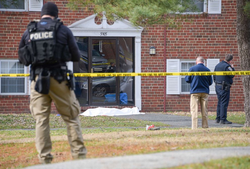 PHOTO: Law enforcement personnel work at the scene which appears to show a body covered under a white blanket outside of an apartment, Wednesday, Feb. 12, 2020, in Baltimore. 