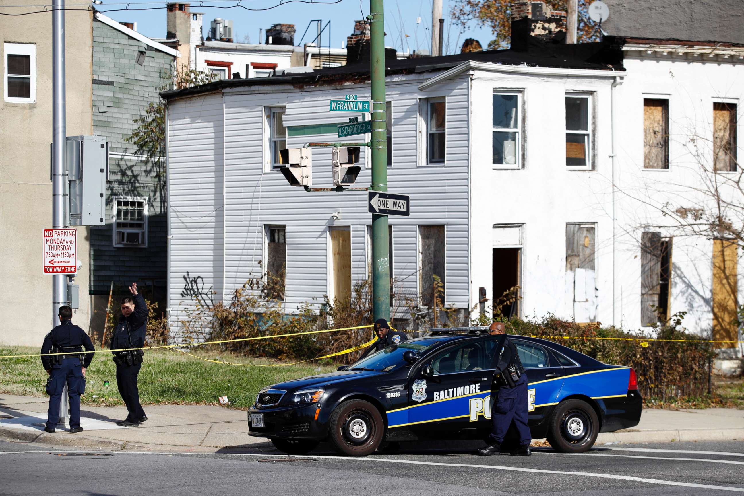 PHOTO: Members of the Baltimore Police Department gather near the scene of the shooting death of Baltimore Police detective Sean Suiter in Baltimore, Nov. 17, 2017. 