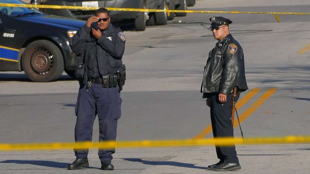 PHOTO: Police stand by inside a taped off area one day following the attack on a Baltimore Police homicide investigator, Nov. 16, 2017.