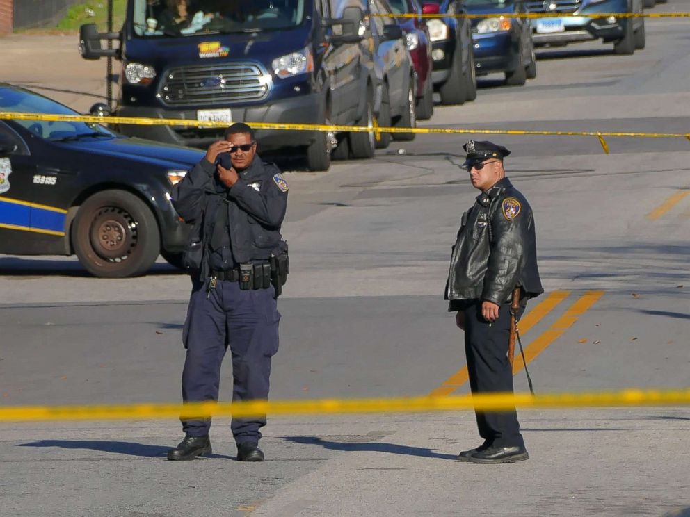 PHOTO: Police stand by inside a taped off area one day following the attack on a Baltimore Police homicide investigator, Nov. 16, 2017.
