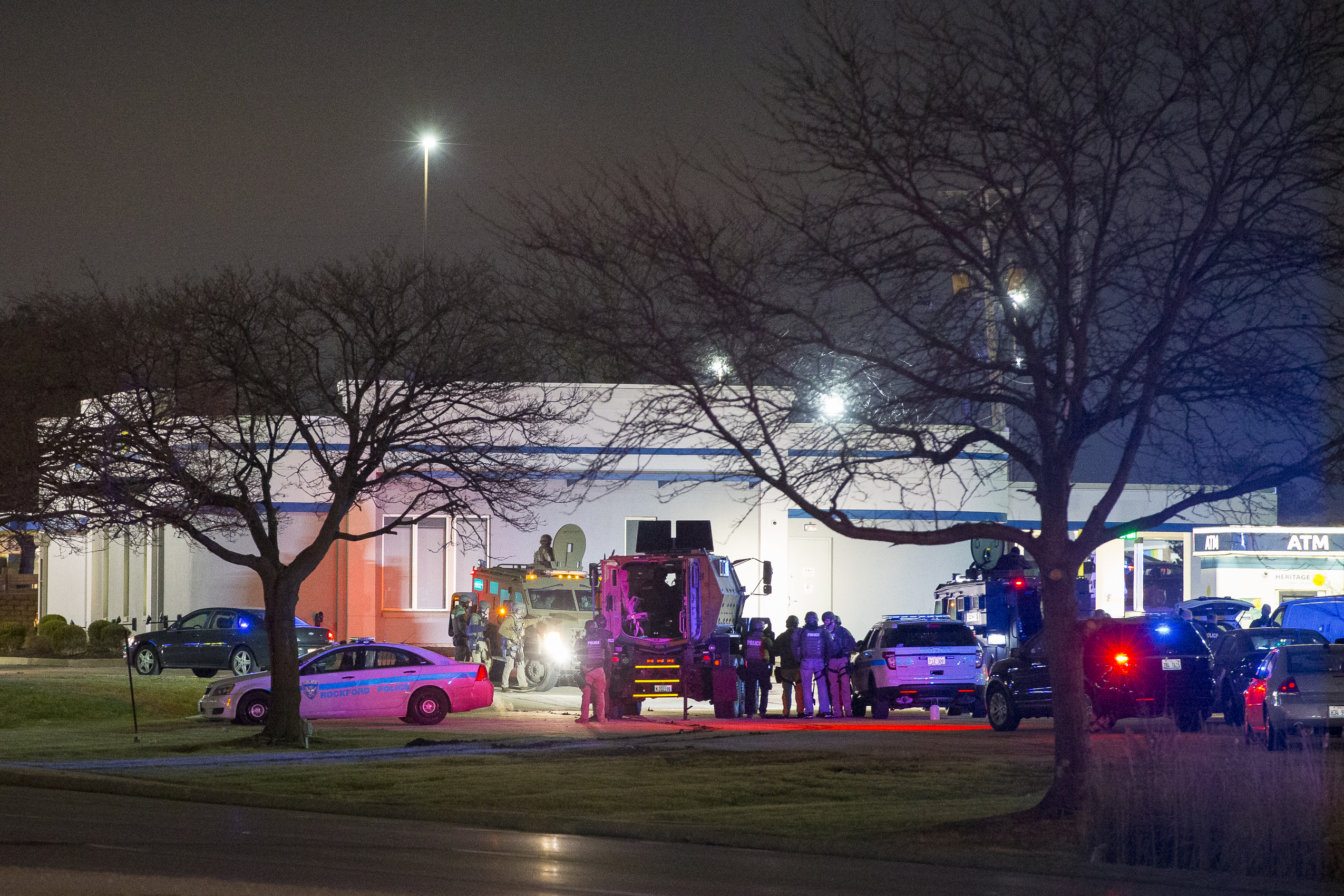 PHOTO: Law enforcement personnel stand guard as an armed man barricaded himself inside an Illinois bank and took a hostage during a robbery Friday, Jan. 3, 2020 in Rockford, Ill. 