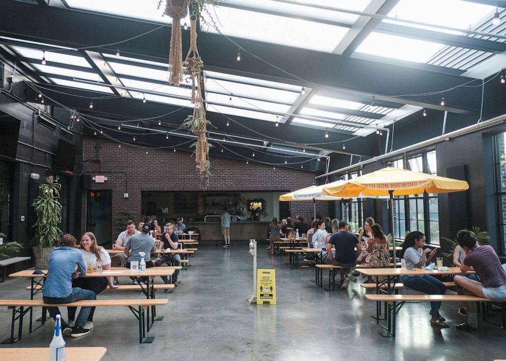 PHOTO: Customers enjoy a last round of drinks at a bar in the Short North District on July 31, 2020 in Columbus, Ohio.