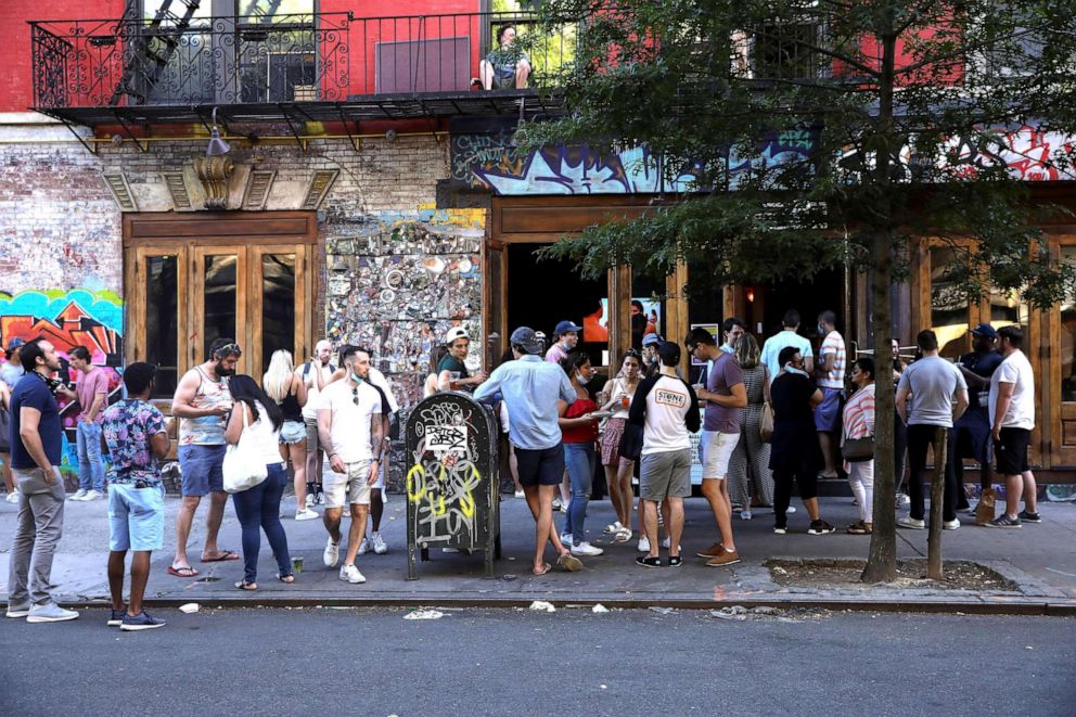 PHOTO: People drink outside a bar during the reopening phase following the coronavirus disease (COVID-19) outbreak in the East Village neighborhood of New York, June 13, 2020.