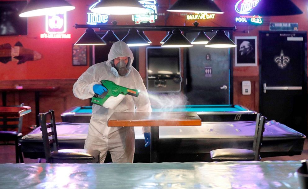 PHOTO: Tyler Page works to disinfect and protect Sharky's Place in Raleigh, N.C., May 22, 2020, before reopening.