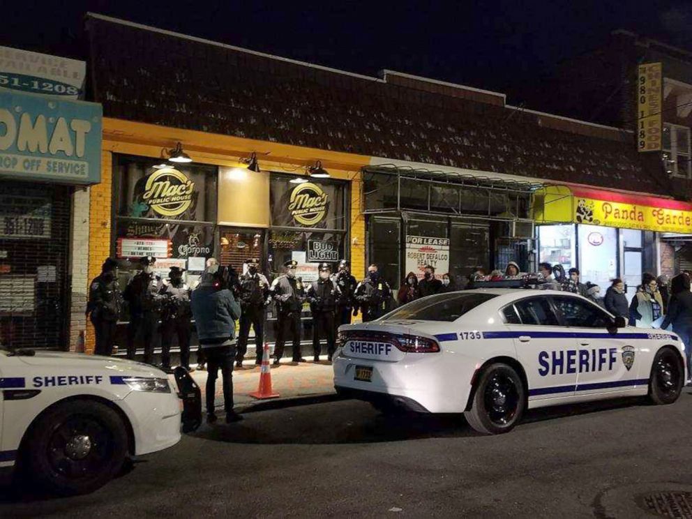 PHOTO: Sheriff's deputies stand outside Mac's Public House in Staten Island, N.Y., Dec. 1, 2020, after shutting the bar down and arresting a co-owner for violating health and safety measures during a surge in COVID-19 infections.