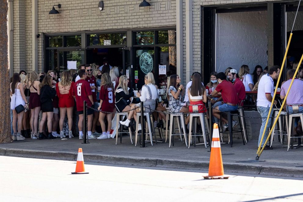 PHOTO: University of Alabama students line up for the bar scene at Twelve25 in Tuscaloosa, as the school and its fans adjust to the new normal on NCAA college football game day on Oct. 3, 2020, amid the coronavirus pandemic.