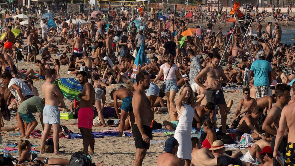 PHOTO: Beachgoers bask in the sun as they enjoy a warm afternoon at Bogatell beach in Barcelona, Spain, July 17, 2020.